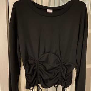 Girl’s black top with broad waist pulled at the front for beautiful style.
